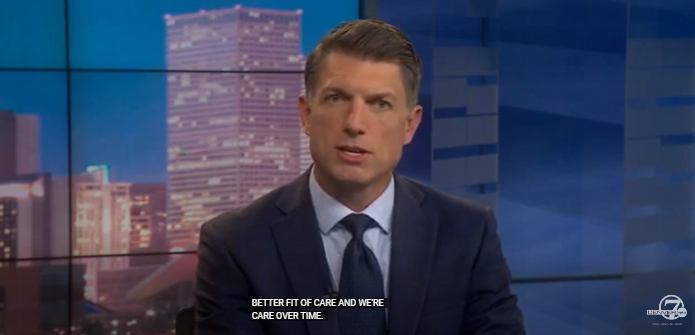 Denver 7 reporter speaking to the camera from the set of the Denver 7 news desk.